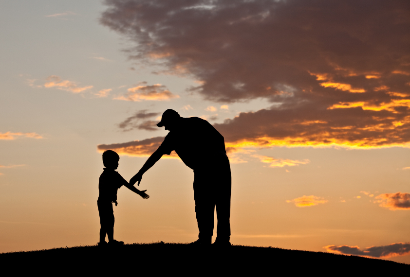 Father reaching out to help his young son