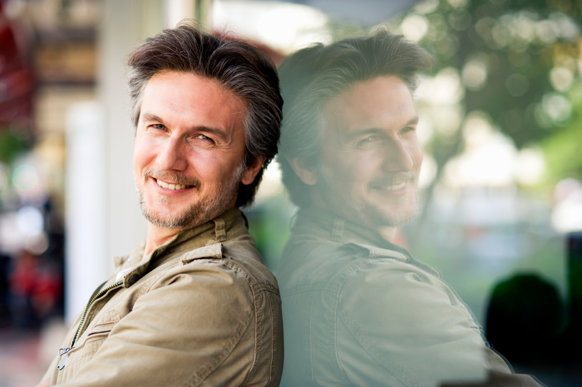 Reflection of man in recovery smiling.