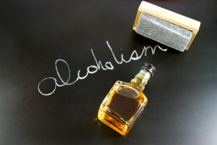alcoholism word on blackboard with eraser.