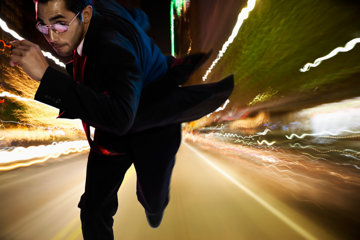 Business executive running at top speed conceptually.