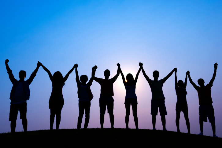 People holding hands to show unity.