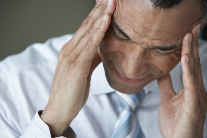 photo of business man holding his temples because his brain is hurting