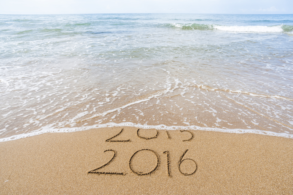 2015 fading into 2016 on the beach with ocean coming in
