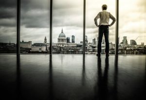 executive_contemplatively_looking_out_corporate_office_window